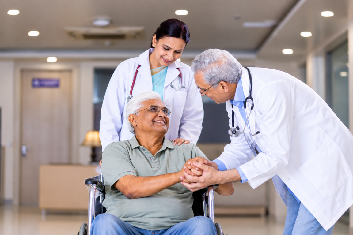 Indian elderly patient receiving kind support from doctors